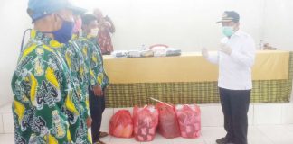 Caption : Bupati Kabupaten Keerom, Muh Markum saat menyerahkan Masker kepada masyarkat Yaturaharja Arso distrik Arso Barat, Selasa (21/04/2020). Pemberian Masker untuk mencegah penyebaran Covid-19 di kabupaten Keerom
