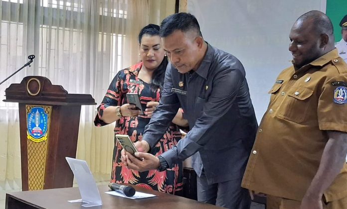 Plt. Sekda Kabupaten Jayapura, Dr. Abdul Rahman Basri, S.Sos., M.KP., mewakili Bupati saat melounching OAPShop.id dengan melakukan scne barcode