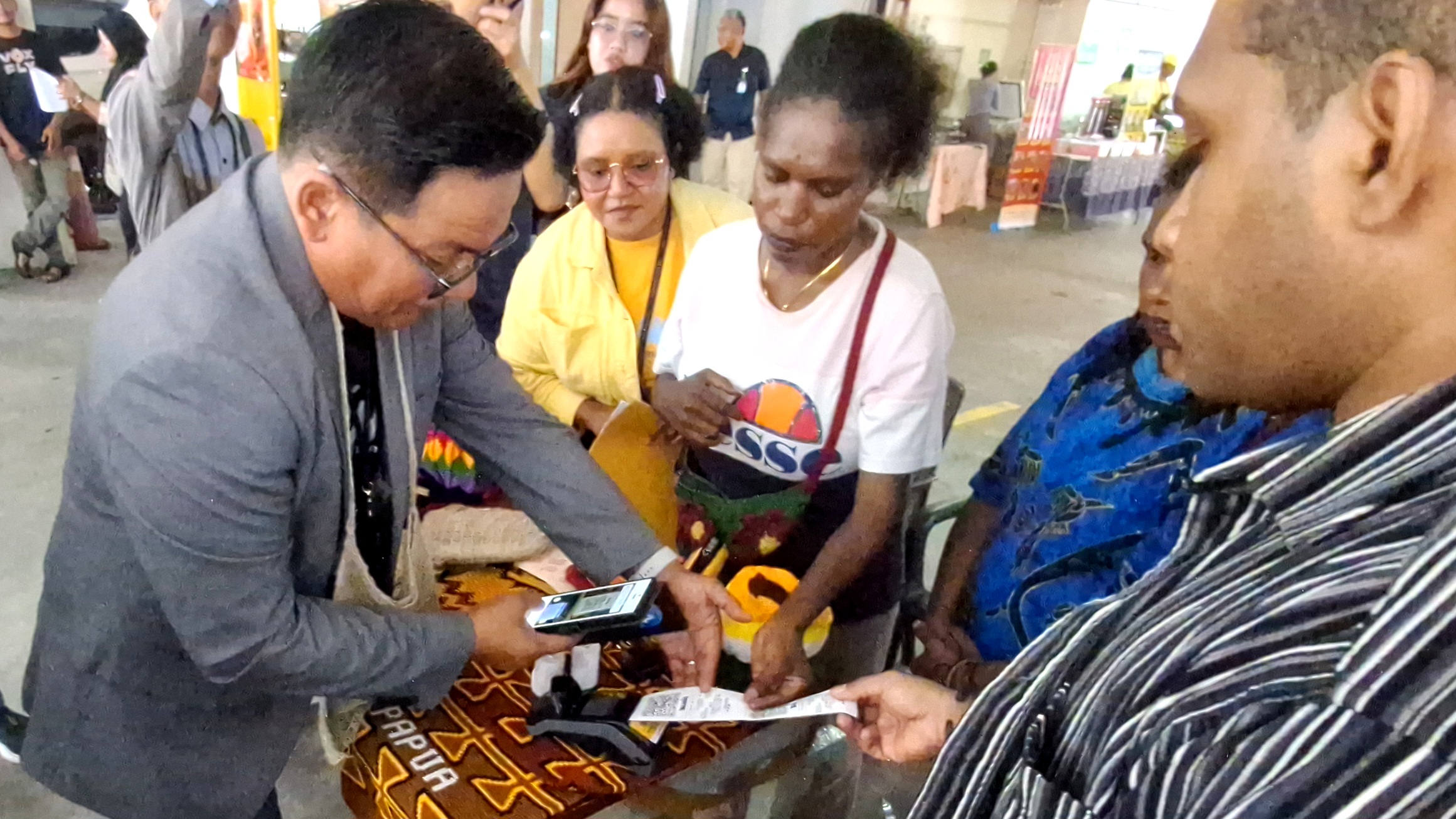 Regional CEO Bank Mandiri Region XII Papua, Antonius Budi Setiawan saat melakukan pembelian noken hasil kerajinan UMKM Mama-Mama Papua di arena Mandiri Vaganza Vol. 5 Auto Housing & UMKM Expo, Kamis (20/8/26)